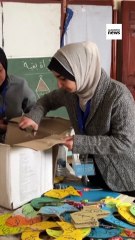 Palestinian volunteers make cardboard Ramadan lanterns