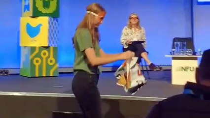 Protesters dressed as carrots storm stage to interrupt environment secretary’s speech at NFU conference