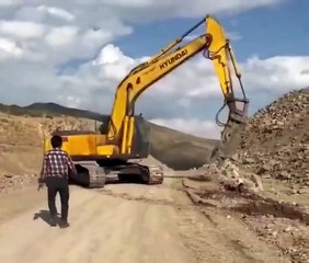 Man stopping a spinning excavator scary