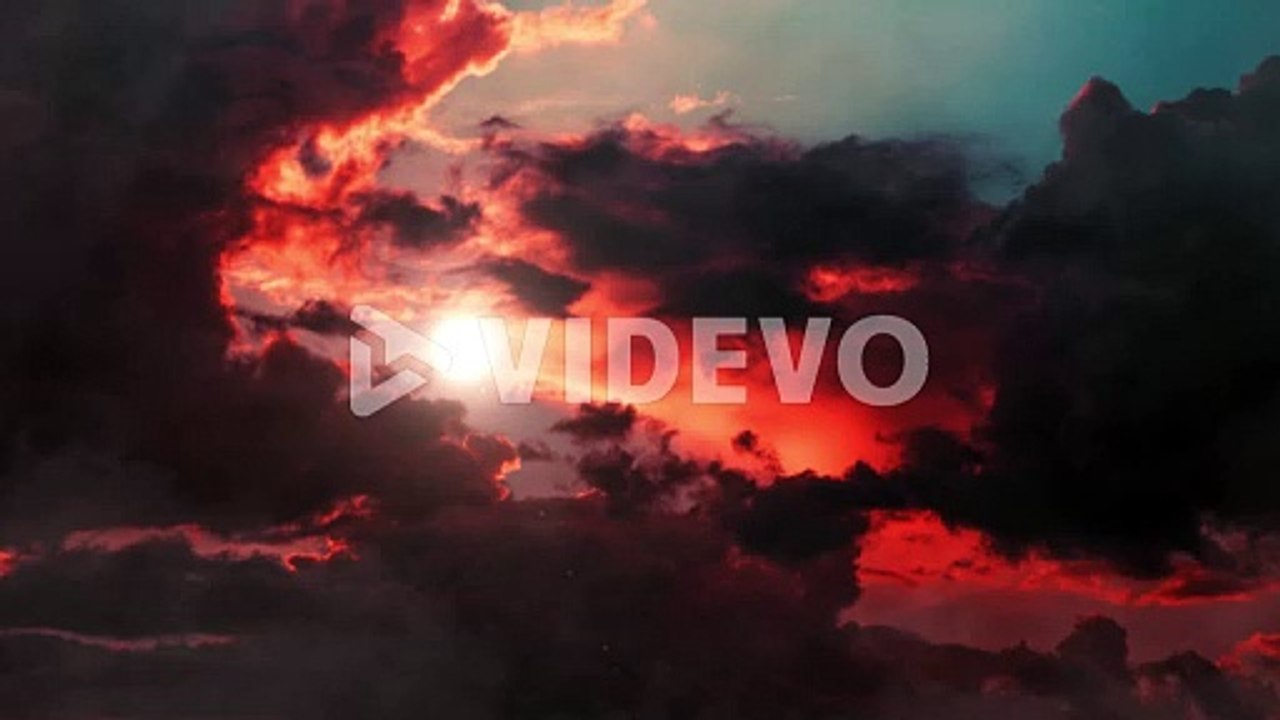 cumulus clouds and sun that shines at sunrise or sunset moving across the blue sky