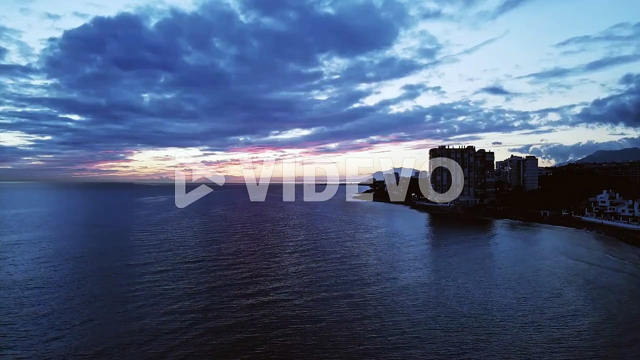 Cinemagraph loop of aerial view of the shoreline during sunrise or sunset
