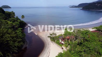 Aerial view overlooking the Barra Do Sahy beach, in sunny San Sebastian, Brazil
