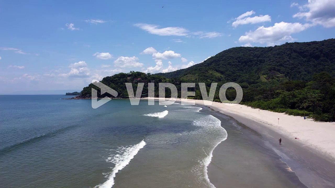 Aerial view over the Barra Do Sahy beach, sunny day in Sao sebastiao, Brazil