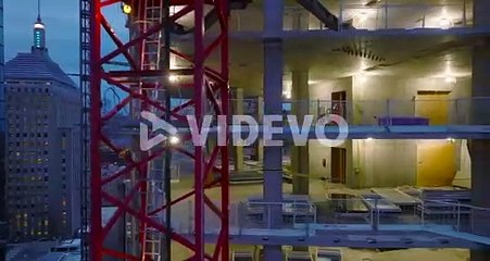 Flight around construction site, illuminated structure of new high rise building
