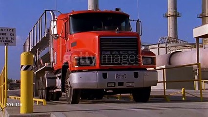 gettyimages-701-115-640_adppMedium shot red hazardous materials truck driving past refinery - HD stock video