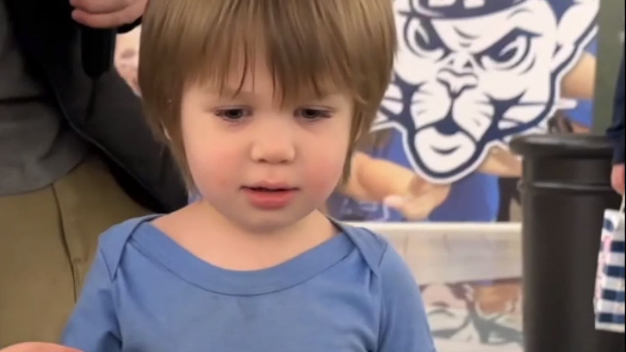 2-year-old toddler tries to bravely conquer his fear of escalators