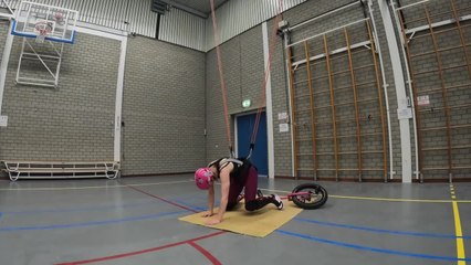 Woman Tries Unicycle Stunt While Being Tied to Harness