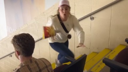 Woman heading up a stairway loses her balance and spills popcorn on a guy *Hilarious*