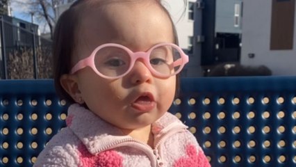Grateful girl stares in awe at the sky after putting on her new glasses