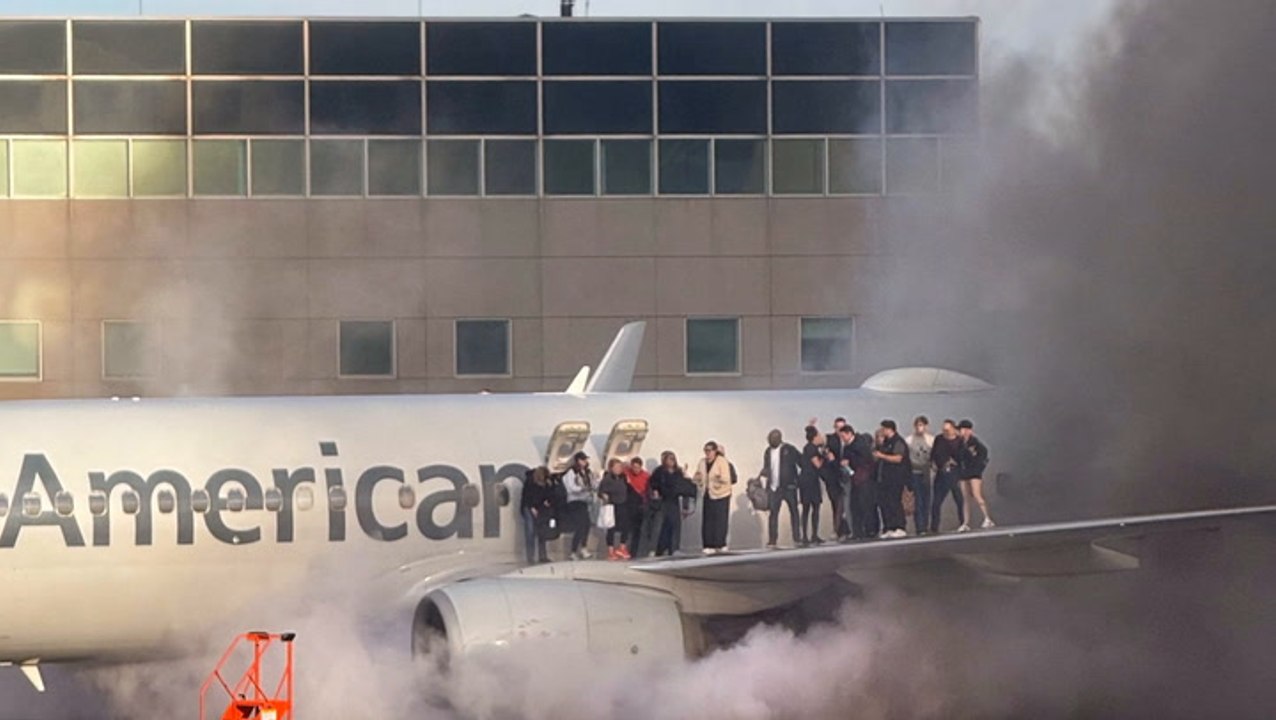 Watch: American Airlines plane bursts into flames as passengers escape on wing