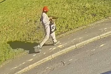 CCTV captures moment masked thug wanders street with air rifle after violent house raid in Colne