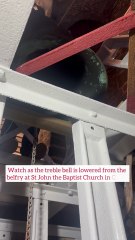 The treble bell is lowered from the belfry at St John the Baptist Church in Corby