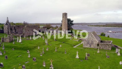 Smooth aerial pan of Clonmacnoise,,cathedral, round towers and high crosses