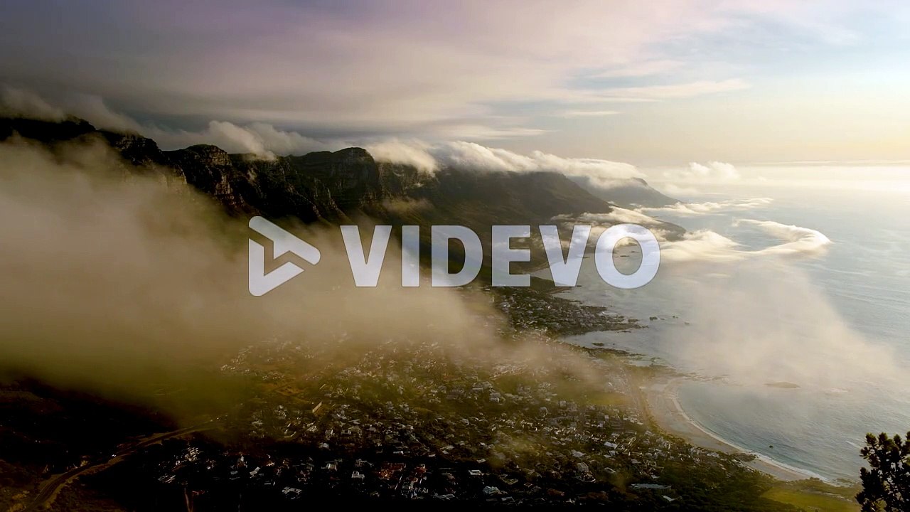 Strange low cloud formations over mountains, Camps Bay in view, Cape Town South Africa