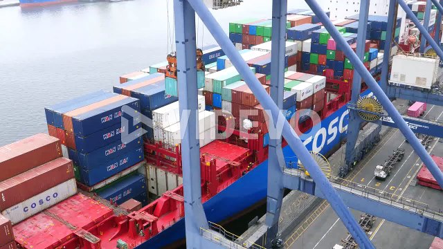 Overlooking Ship Docked At Terminal With Spreader Unloading Container At Karachi Port Trust Terminal