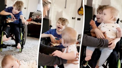 Sweet moment non-verbal boy holds his baby brother on his lap