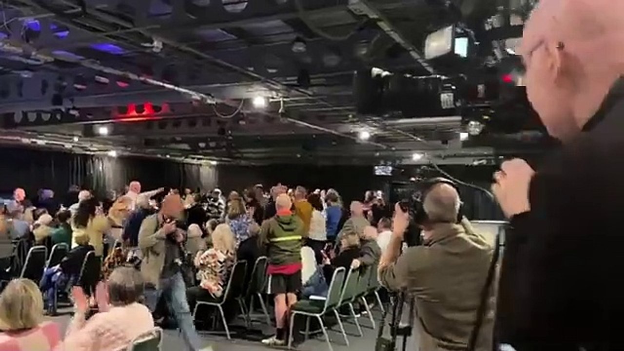 Protester led away by security at Nigel Farage Reform UK rally in Doncaster