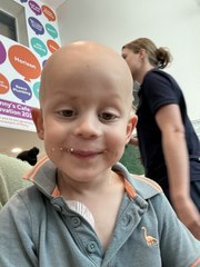 Jackson Fitzgerald rings the bell after his first cancer treatment finished
