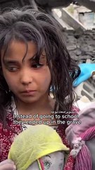 A girl holding the dolls of her friends who were martyred in an Israeli airstrike.