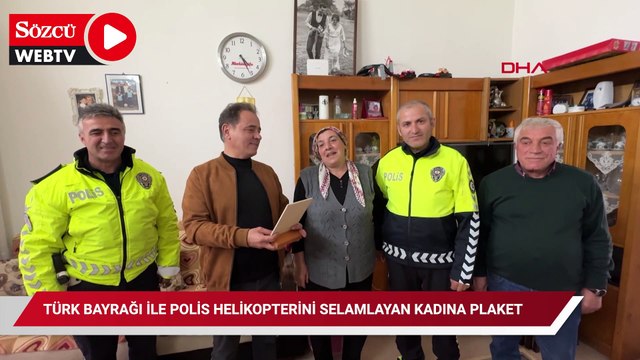 Türk bayrağı ile polis helikopterini selamlayan kadına plaket