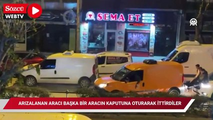 Arızalanan aracı başka bir aracın kaputuna oturarak ayaklarıyla ittirdiler
