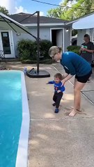 Mother swimming teaching child
