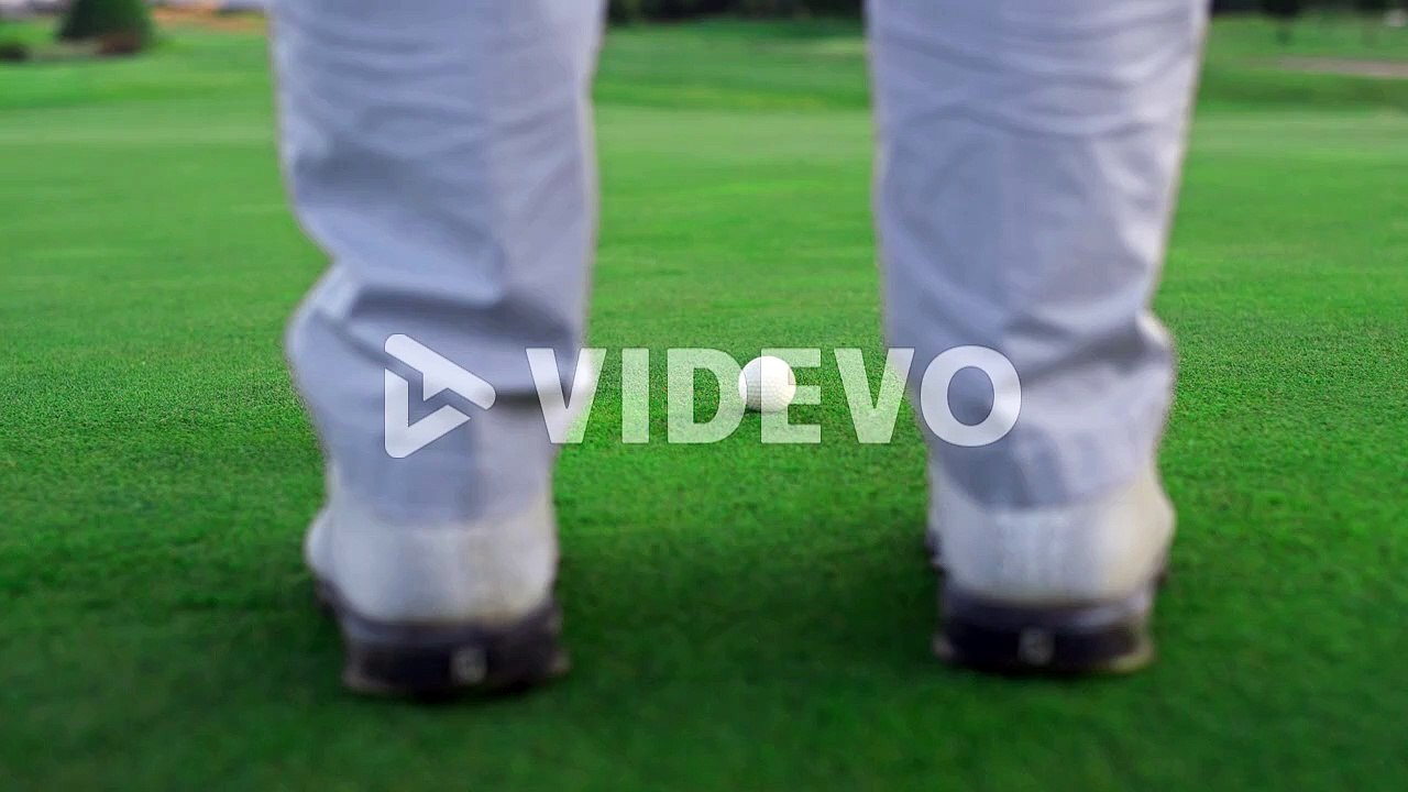 Active golfer swing club on golf course