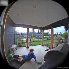 Boy Falls While Trying to Kick Football Into House