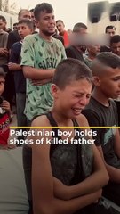 Palestinian boy holds shoes of killed father _ #AJshorts