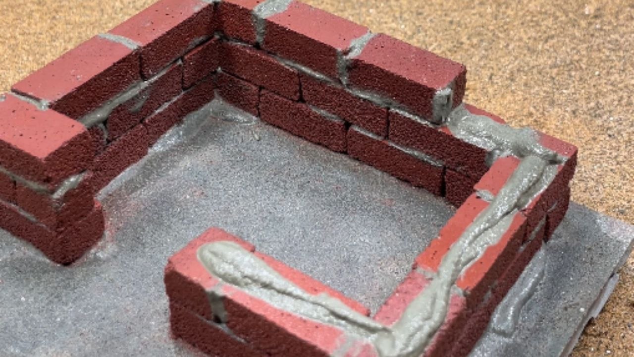 Artist brings a miniature house to life with tiny bricks, window, and front door