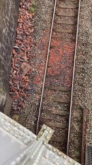 Debris on the railway track after a traffic accident knocked a wall off a bridge