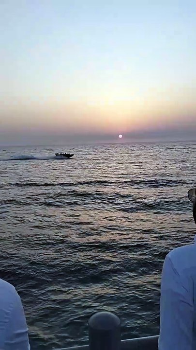 What a beautiful sight of the sun setting in the sea and the boat passing ahead.