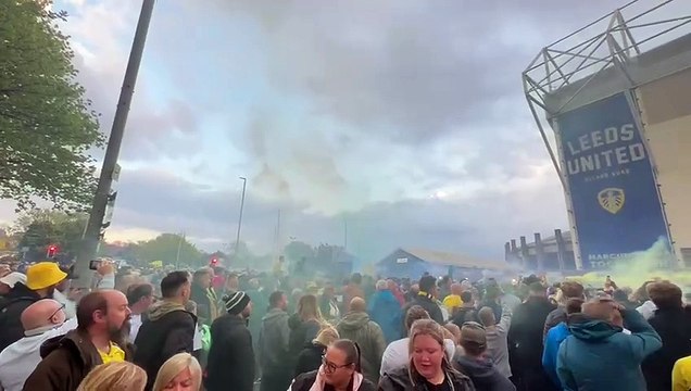 Leeds United supporters celebrate the club's promotion to the Premier League outside Elland Road