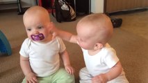 Twins baby girls fight over Pacifier