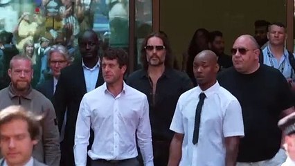 Russell Brand leaves court after hearing over alleged sex offenses