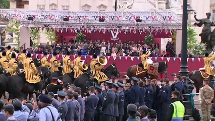 King Charles III salutes VE Day military procession