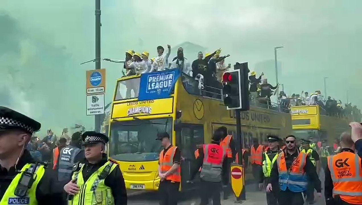 Leeds United players are greeted by fans on their celebration bus parade