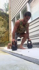 Man Loses Balance While Holding Kettlebells and Falls