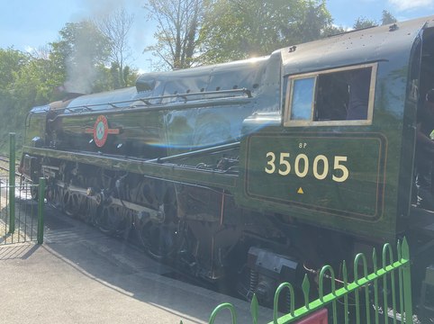The Canadian Pacific steam locomotive arrives to couple up with the 11am VE Day 80 train from Alresford to Alton on the Watercress Line