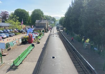 A view from the bridge on the Watercress Line as the VE Day 80 diesel shuttle service leaves Alresford for Alton
