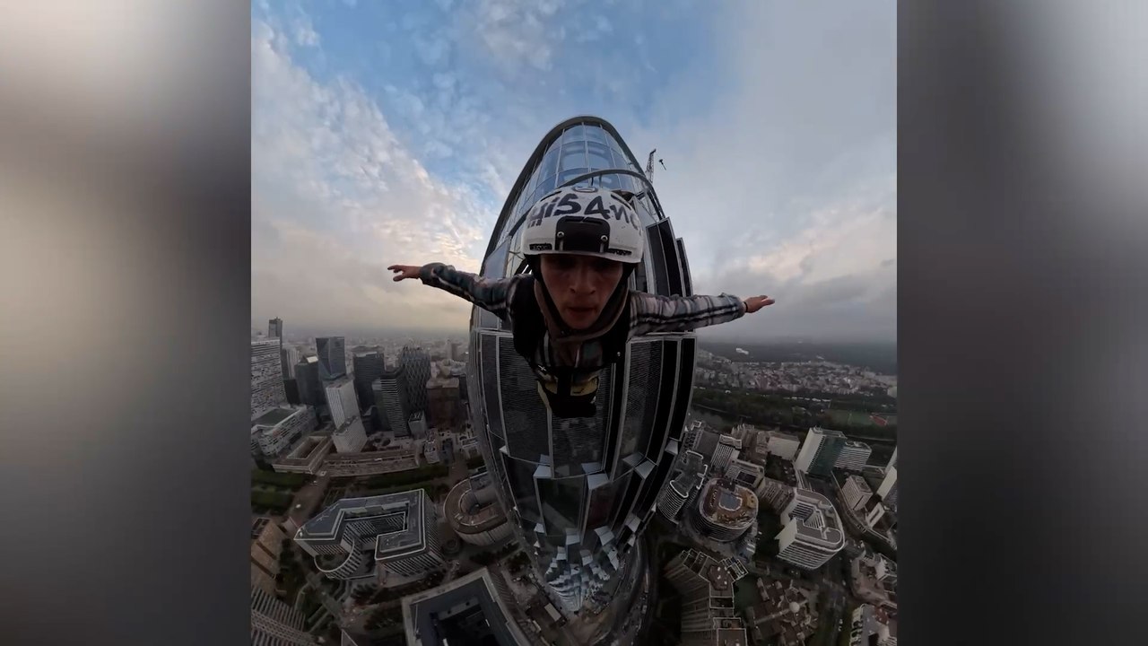 Daredevil Brit sneaks into France's tallest skyscraper and parachutes 845ft off top