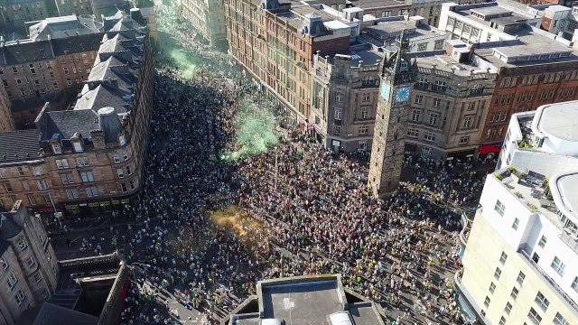Glasgow Celtic fans gather at Glasgow Cross to celebrate winning their 55th Scottish League title.