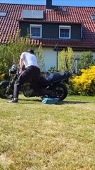 Man Saves Bike From Falling but Then Trips and Falls Backwards