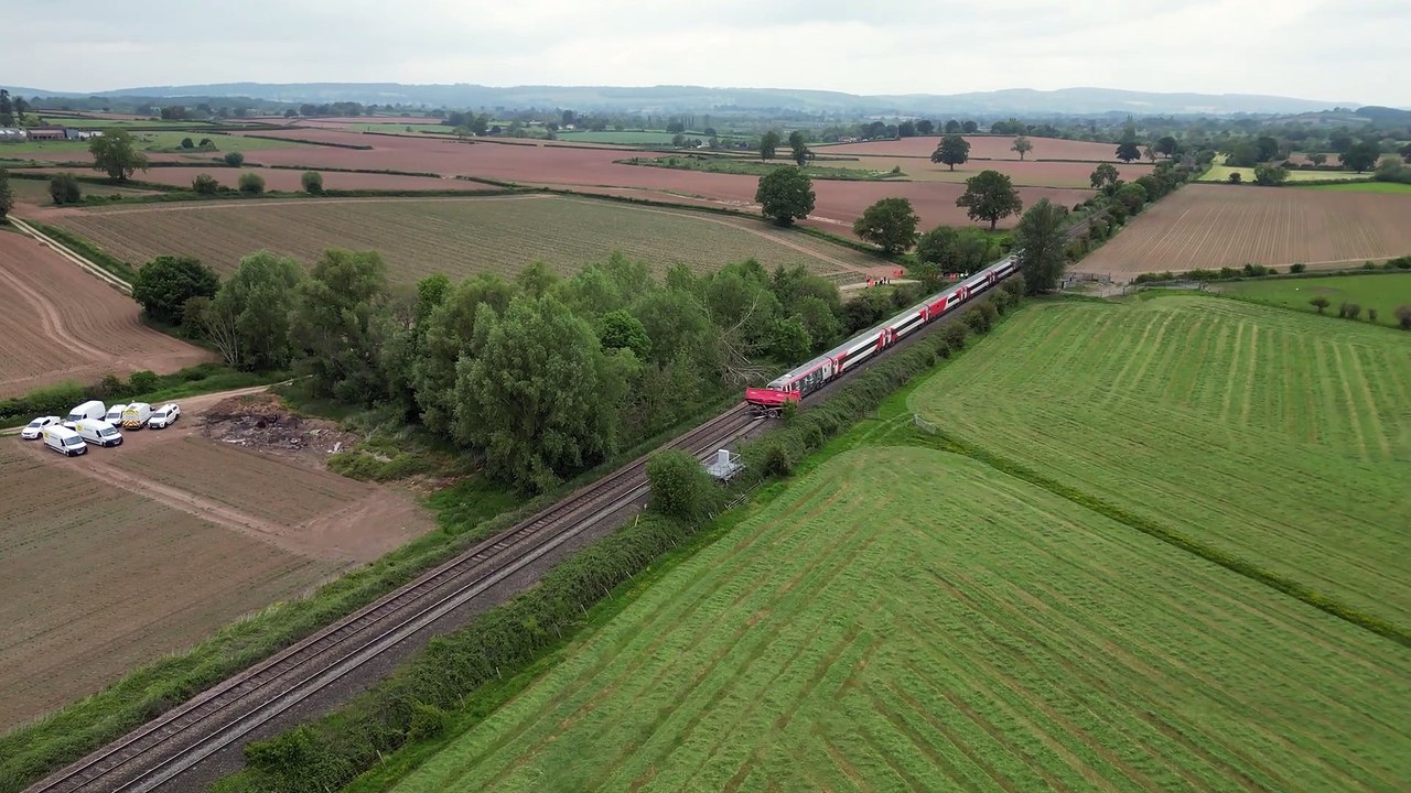 Train smashes into tractor at level crossing - aerial footage
