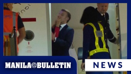 France's first lady seems to push her husband as they land in Vietnam