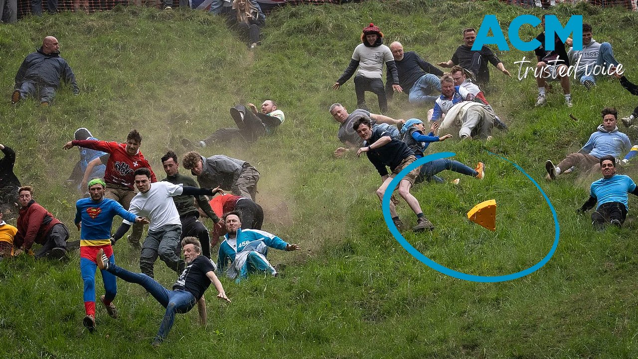 Cheesy chaos: daredevils hurl downhill in wild UK cheese rolling race