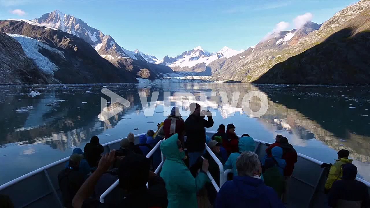 Tourists on the bow of a ship entering Johns Hopkins Inlet in Glacier Bay National Park Alaska
