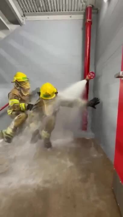 Blindfolded Fire Students Stumble As Hose Sprays And Stairs Make It Harder