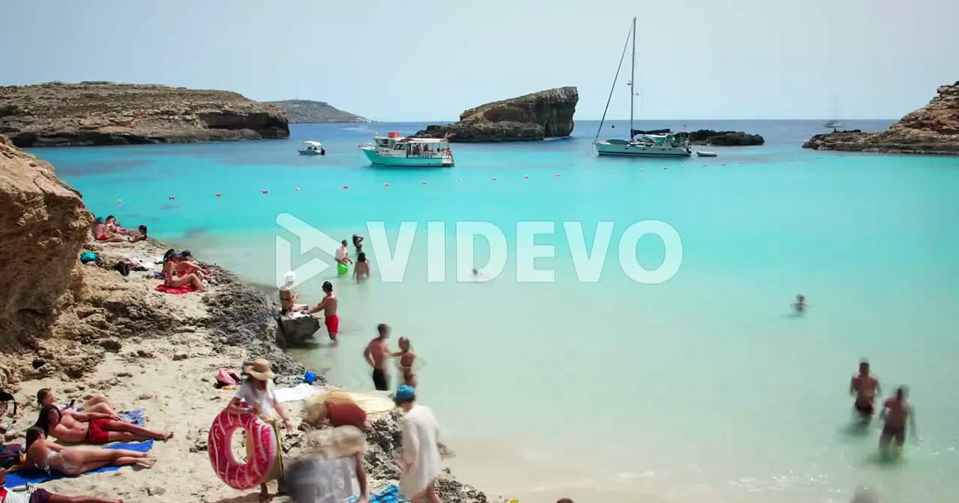 Tourists And Boats In Blue Lagoon Of Comino Island In Malta At Summer