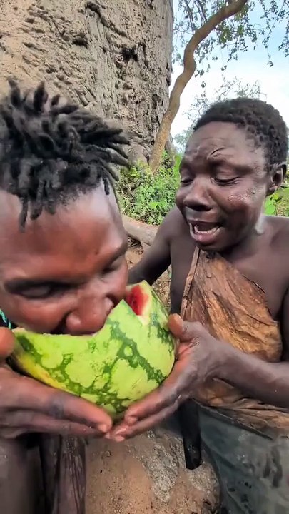 Hadzabe Tribe bush people are really happy today to try this new fruit, they got it from neighboring tribe for some bush food in exchange as Hadzabe life is adventurous and they like to try new things sometimes